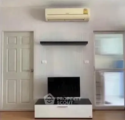 Modern living room with air conditioning and sleek TV setup