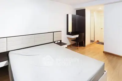 Spacious modern bedroom with sleek design and ample natural light