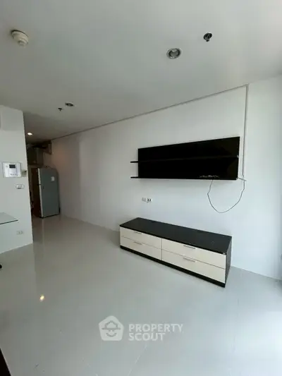 Modern minimalist living room with sleek TV stand and wall-mounted screen
