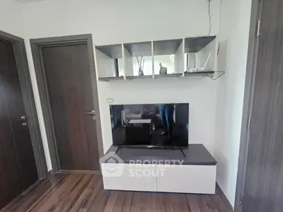 Modern living room with sleek TV stand and wall-mounted shelves