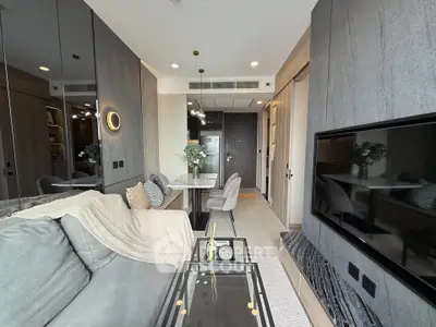 Modern living room with sleek design, featuring a cozy sofa, wall-mounted TV, and stylish decor.