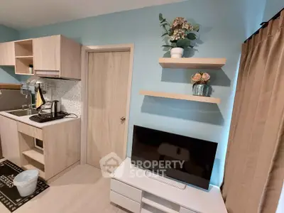 Modern compact living room with stylish kitchen and TV setup