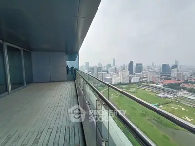 Stunning high-rise balcony with panoramic city skyline view, perfect for urban living enthusiasts.
