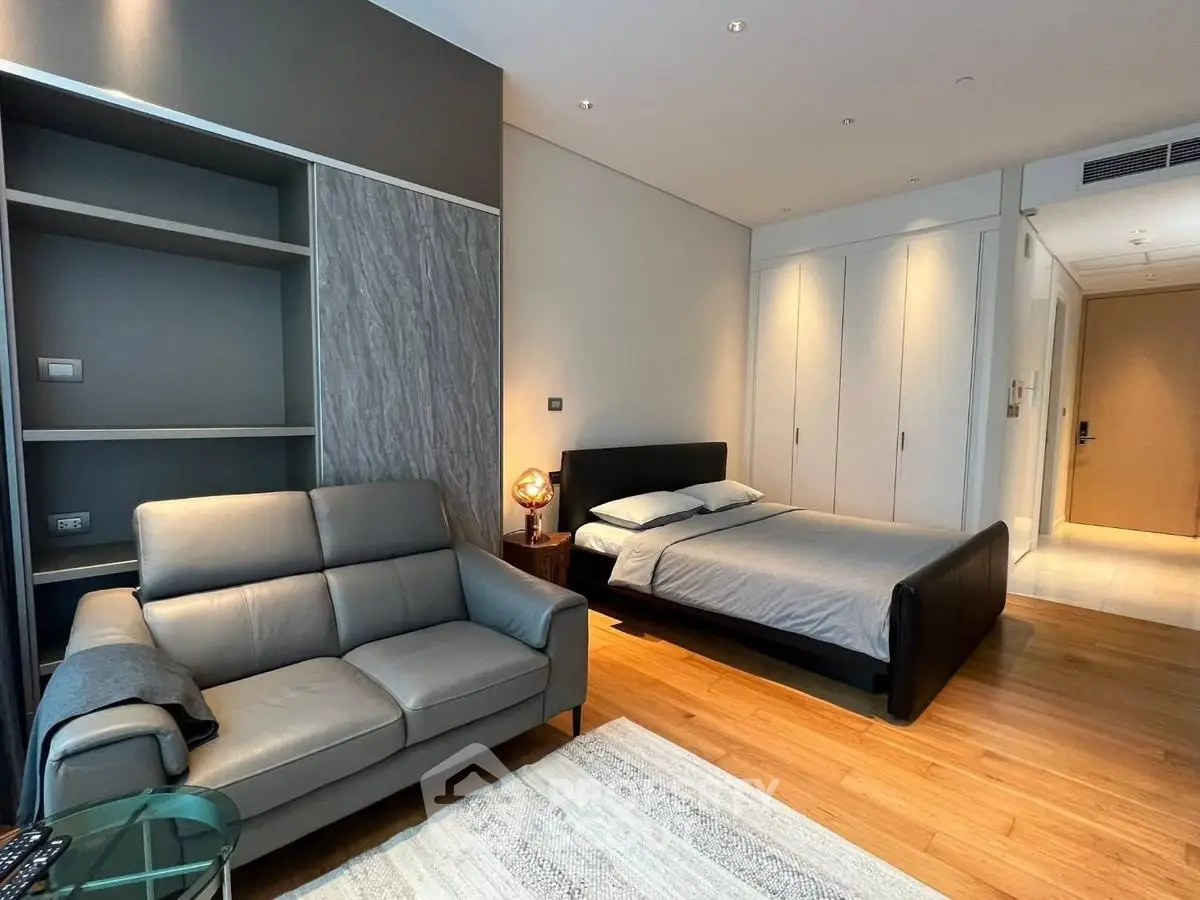 Modern bedroom with sleek design and cozy seating area