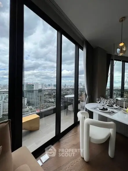 Stunning city view from modern dining area with floor-to-ceiling windows and balcony access.