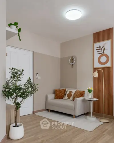 Stylish living room with modern decor, featuring a cozy sofa, elegant wall art, and lush indoor plants.