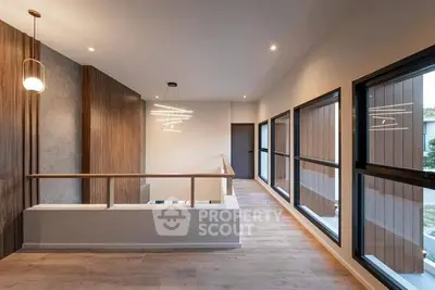 Modern hallway with large windows and stylish lighting in a contemporary home.