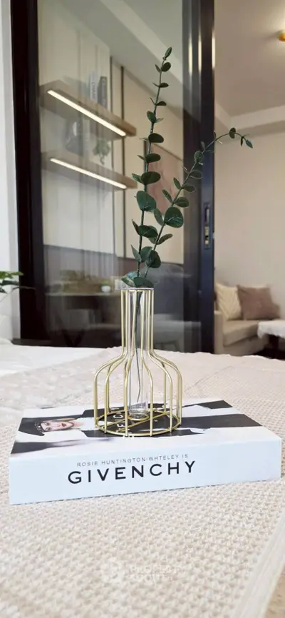 Stylish modern interior with elegant decor and cozy ambiance, featuring a designer book and vase.