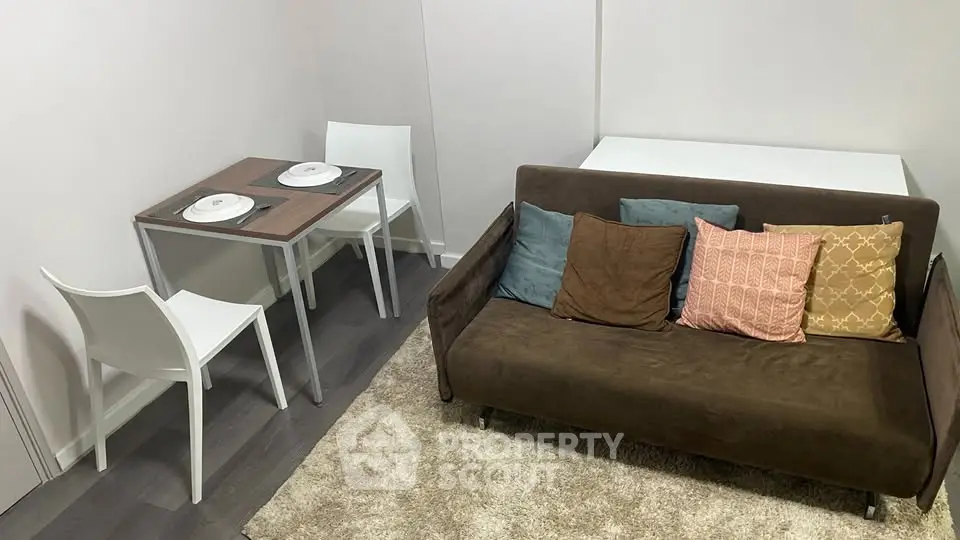 Cozy living room with modern sofa and dining area in compact apartment