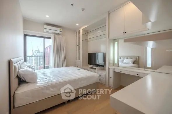 Modern bedroom with built-in storage and city view, featuring sleek design and natural light.
