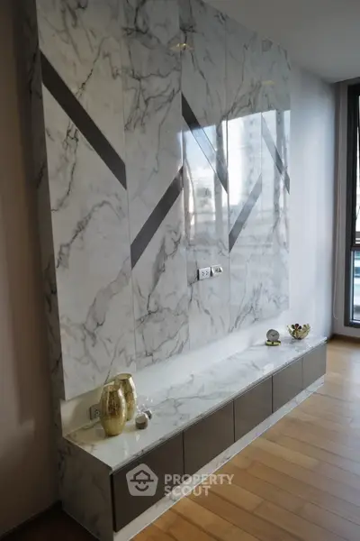 Luxurious marble accent wall with built-in storage in modern apartment