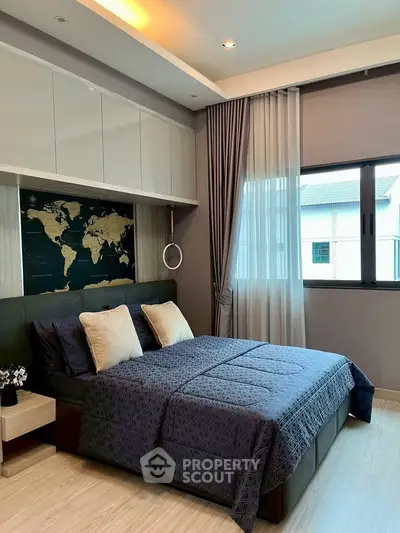 Modern bedroom with stylish decor and large window for natural light