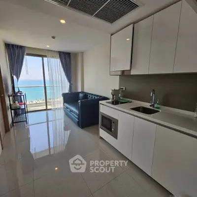 Modern kitchen with ocean view and sleek cabinetry in a stylish apartment.