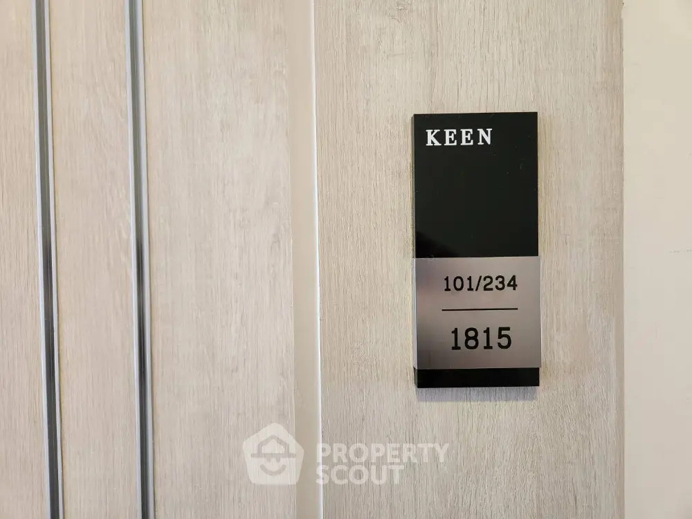 Modern apartment door with sleek room number plaque for unit 1815.