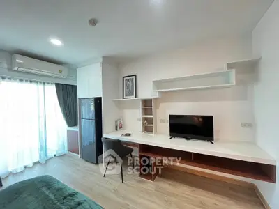 Modern studio apartment with sleek furnishings and natural light