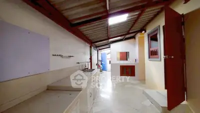 Spacious kitchen with open layout and modern fixtures in a well-lit home.