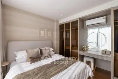 Luxurious bedroom with elegant decor and built-in wardrobe, featuring a stylish vanity and air conditioning.
