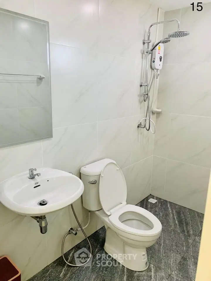 Modern bathroom with sleek fixtures and a shower in a contemporary real estate property.