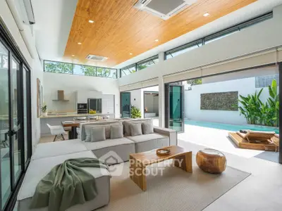 Luxurious open-plan living room with pool view and modern decor