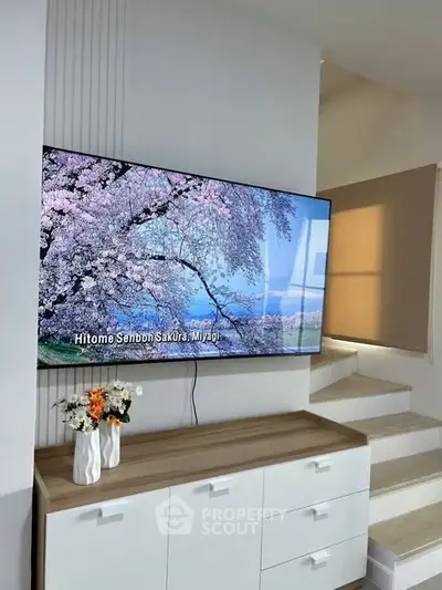 Modern living room with wall-mounted TV and stylish decor