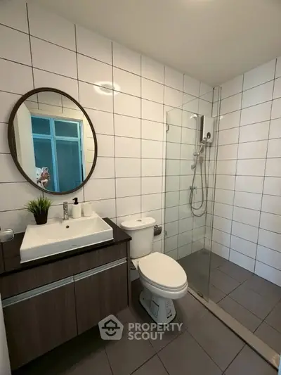 Modern bathroom with sleek fixtures and glass shower enclosure