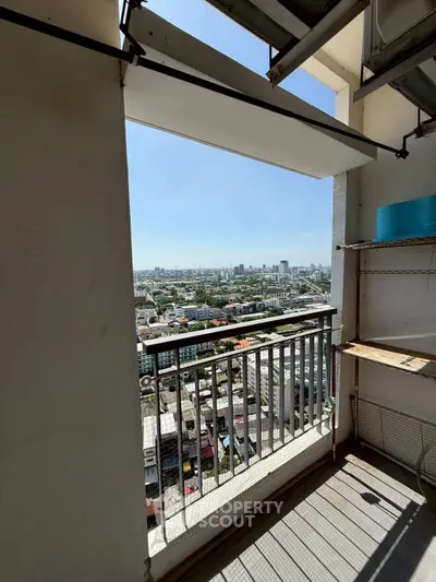 Stunning cityscape view from a high-rise balcony with clear skies and urban skyline.
