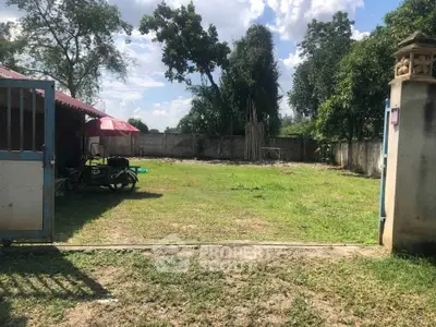 Spacious vacant land with lush greenery and clear blue sky, ideal for development opportunities.