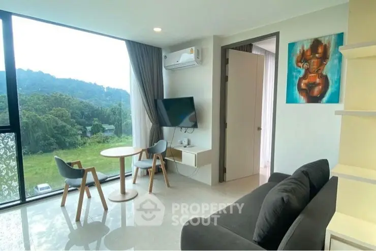 Modern living room with scenic view, featuring sleek furniture and large windows.