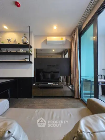 Modern living room with sleek decor and balcony access in a stylish apartment.