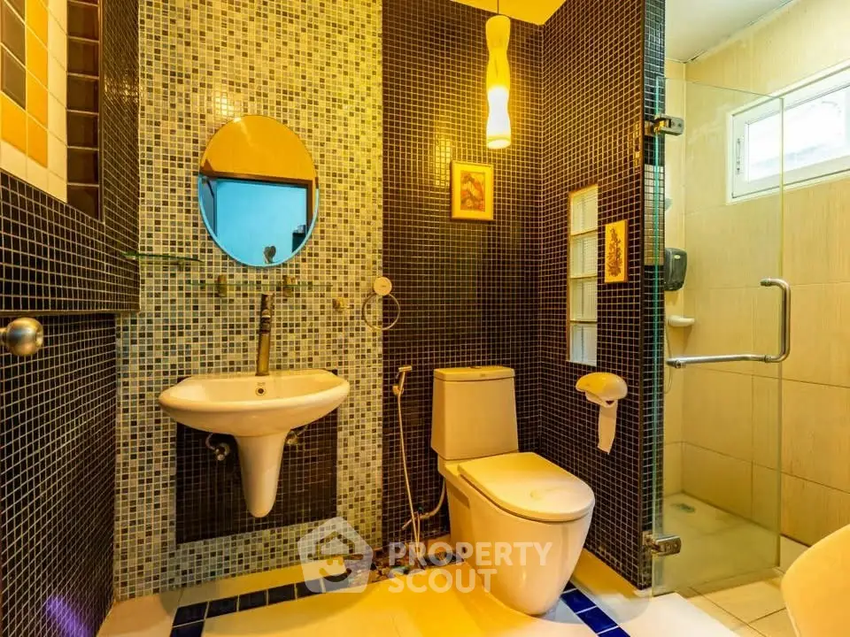 Modern bathroom with stylish mosaic tiles and sleek fixtures