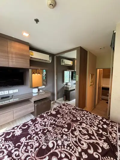 Modern bedroom with stylish decor and mirrored wardrobe in a cozy apartment.