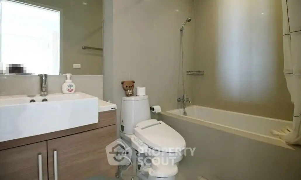 Modern bathroom with sleek fixtures and bathtub in a stylish apartment.