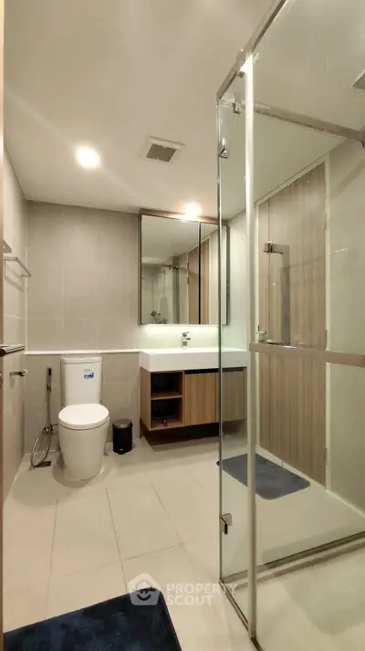 Modern bathroom with glass shower and sleek fixtures