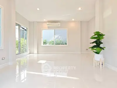 Spacious sunlit living room with modern design and large windows