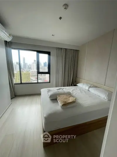 Modern bedroom with city view in high-rise apartment