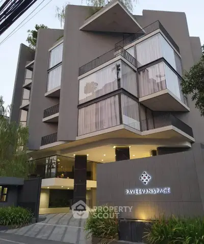 Modern architectural building with sleek design and large windows in urban setting.