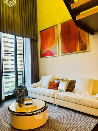 Luxurious living room with high ceilings, modern decor, and large windows offering stunning city views.