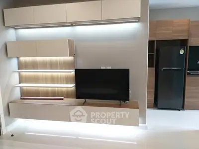Modern living room with sleek TV unit and stylish kitchen appliances