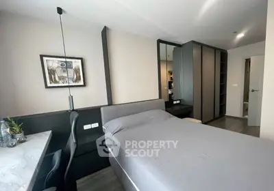 Modern bedroom with sleek design and ample storage in a stylish apartment.