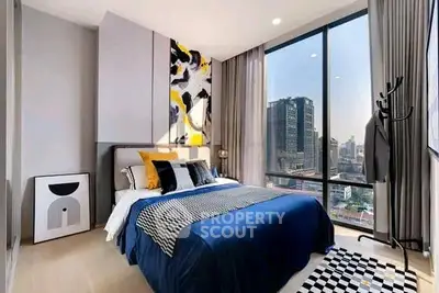 Modern bedroom with floor-to-ceiling windows offering stunning city views, stylish decor, and ample natural light.