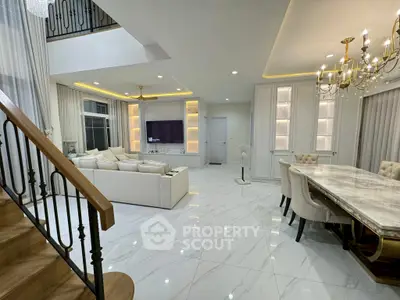 Luxurious open-plan living room with elegant dining area and modern staircase