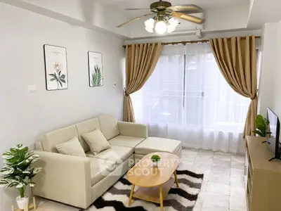 Stylish living room with beige sofa, modern decor, and natural light.
