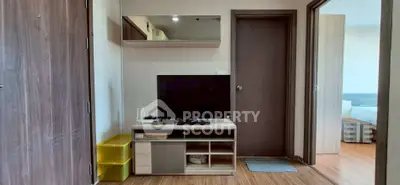 Modern apartment interior with TV unit and wooden flooring