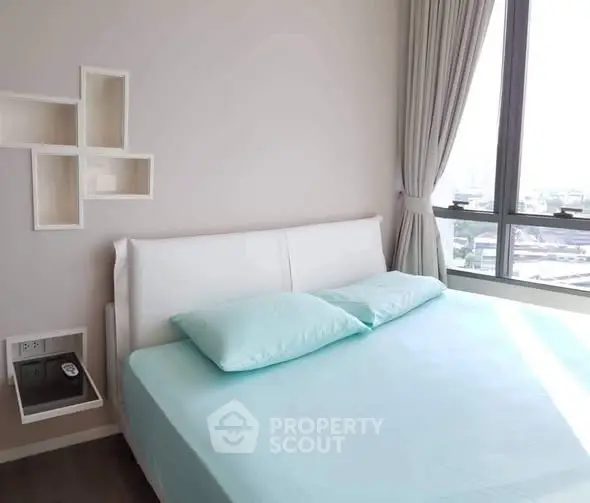 Modern bedroom with large window and stylish decor