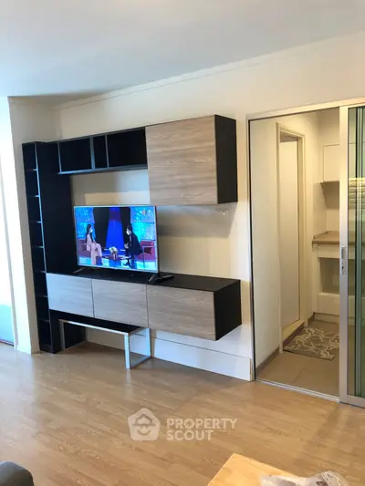 Modern living room with sleek entertainment unit and wooden flooring