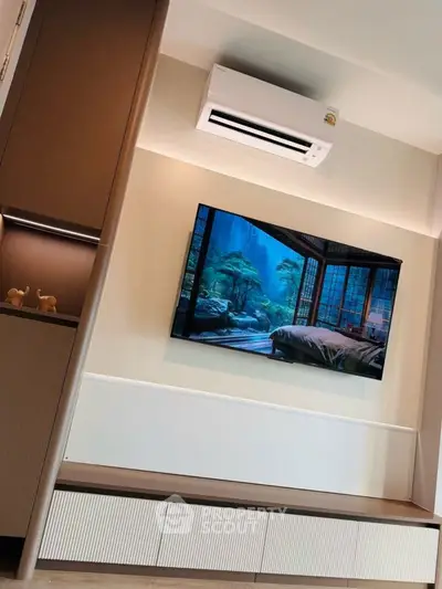 Modern living room with wall-mounted TV and air conditioning unit