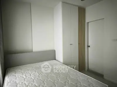 Modern minimalist bedroom with built-in wardrobe and cozy bed