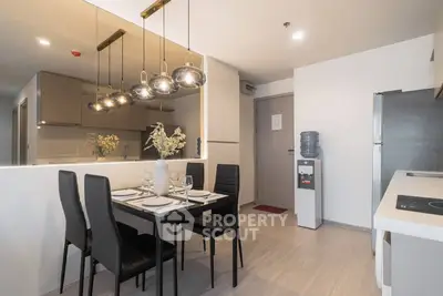 Modern dining area with stylish lighting and sleek kitchen design