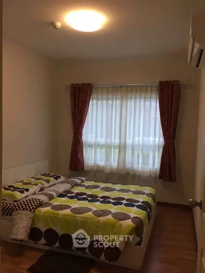 Cozy bedroom with modern decor and natural light, featuring a stylish bed and elegant curtains.