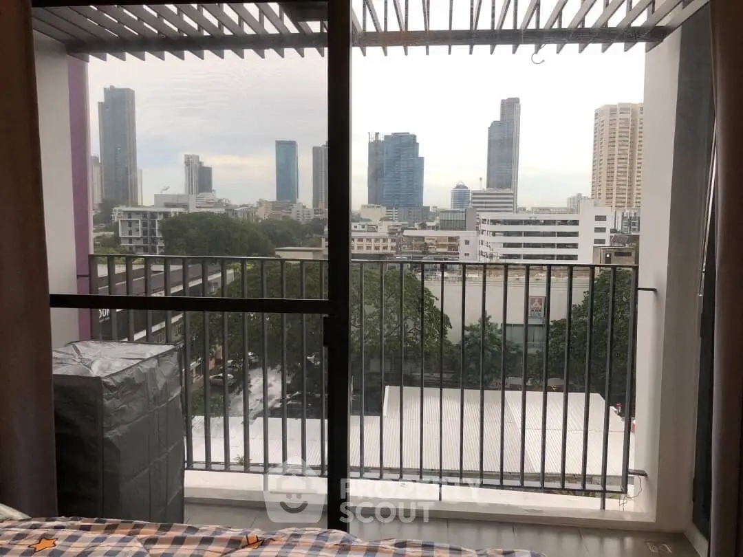 Stunning city view from a modern apartment balcony with skyline backdrop.